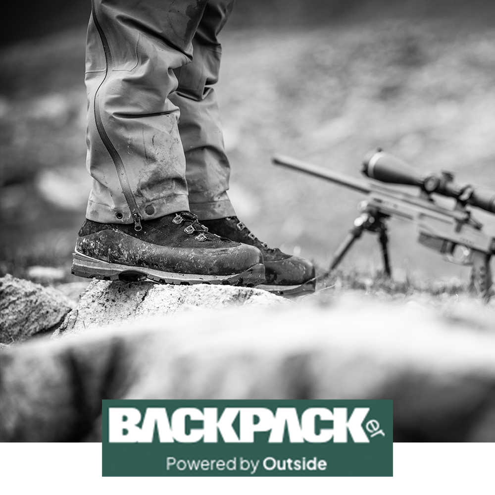 Meindl Air Revolution Alpine Pro 200 – As Featured in Backpacker Magazine Powered by Outside – Insulated Gore-Tex Waterproof Hiking Boot Worn by Hunter Standing on Rocky Terrain With Scoped Rifle Visible