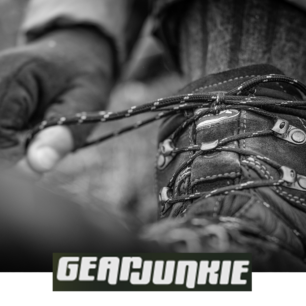 Meindl Air Revolution Alpine Pro 200 – As Featured in Gear Junkie – Insulated Gore-Tex Waterproof Hiking Boot Close-Up Showing Hiker Lacing the Boot With Gloved Hands in Cold Conditions