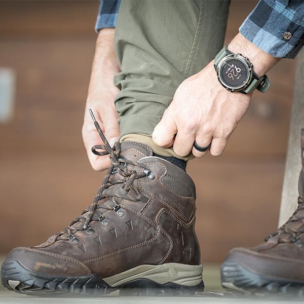 Meindl Comfort Fit Light Hiker – Dark Brown Full-Grain Leather Comfort Fit Hiking Boot Being Pulled On Indoors Before a Hike