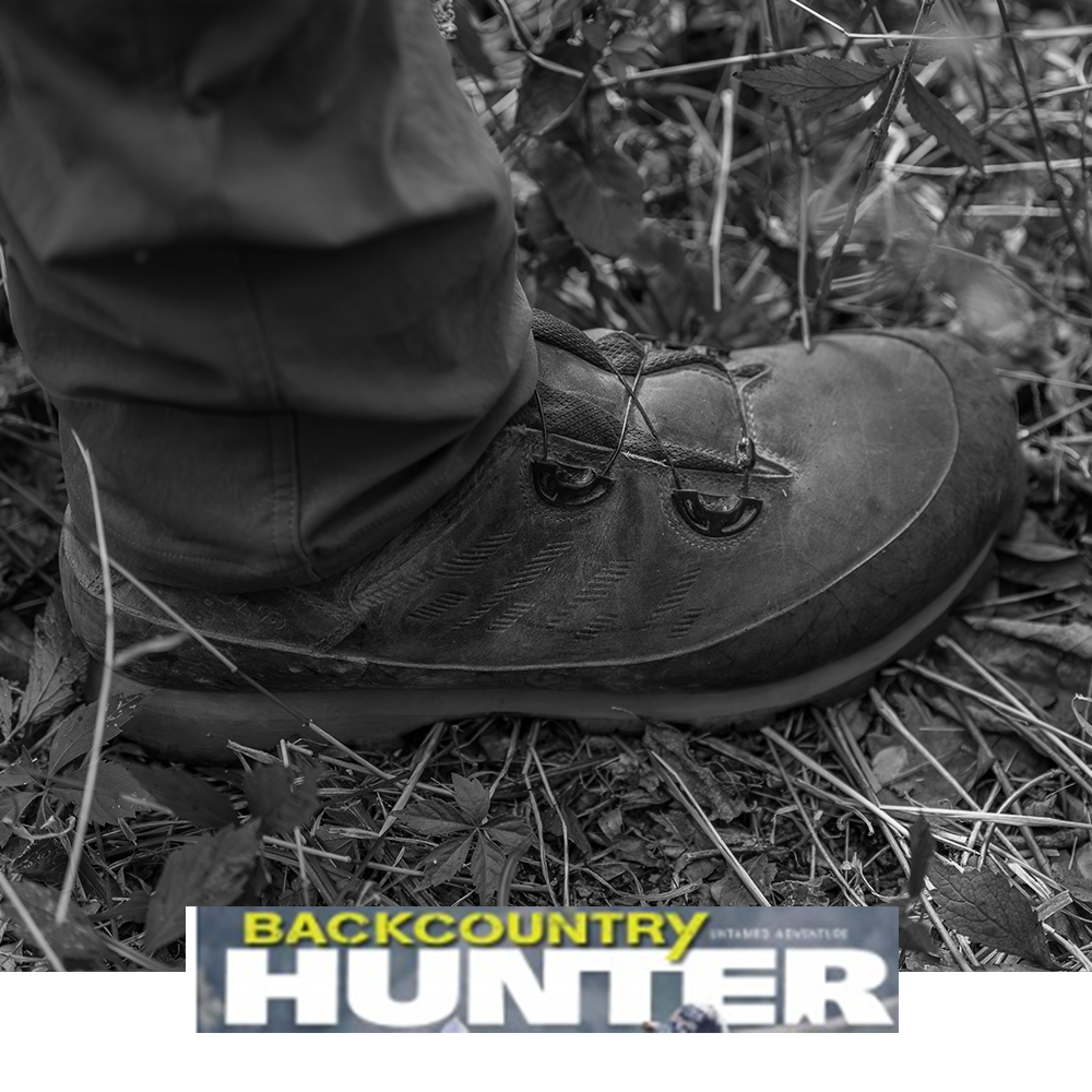 Meindl Comfort Fit Boa Speed Hunter – As Featured in Backcountry Hunter Magazine – Boa Speed Lacing Hunting Boot Worn by Hunter Standing on Forest Floor Among Leaves and Undergrowth