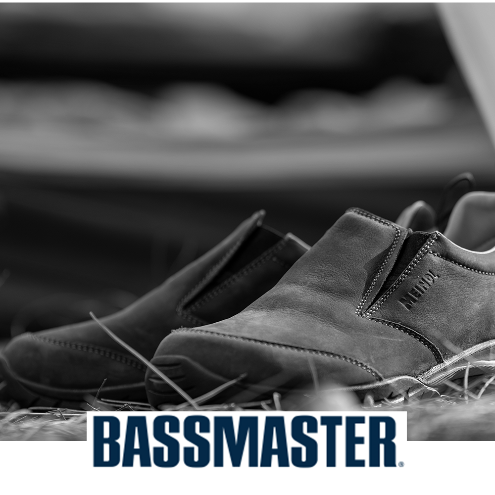 Meindl Comfort Fit Camp Moc Slip-On – As Featured in Bassmaster Magazine – Leather Moccasin Slip-On Camp Shoe Resting on Dry Grass Beside a Tackle Box in a Fishing and Outdoor Context