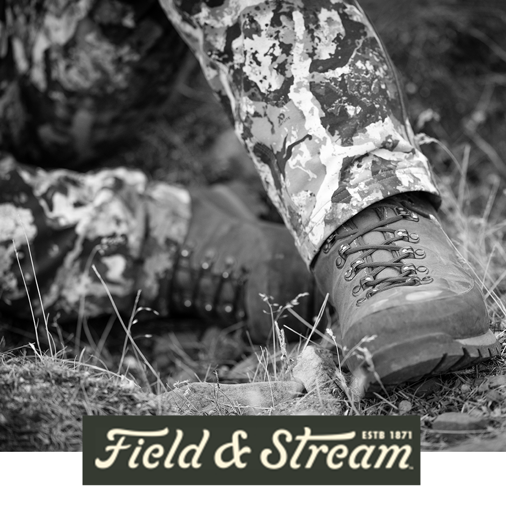 Meindl Comfort Fit Extreme – As Featured in Field and Stream Magazine – Heavy-Duty Leather Hunting Boot Worn by Hunter in Camouflage Kneeling on Rocky Terrain in Mountain Setting