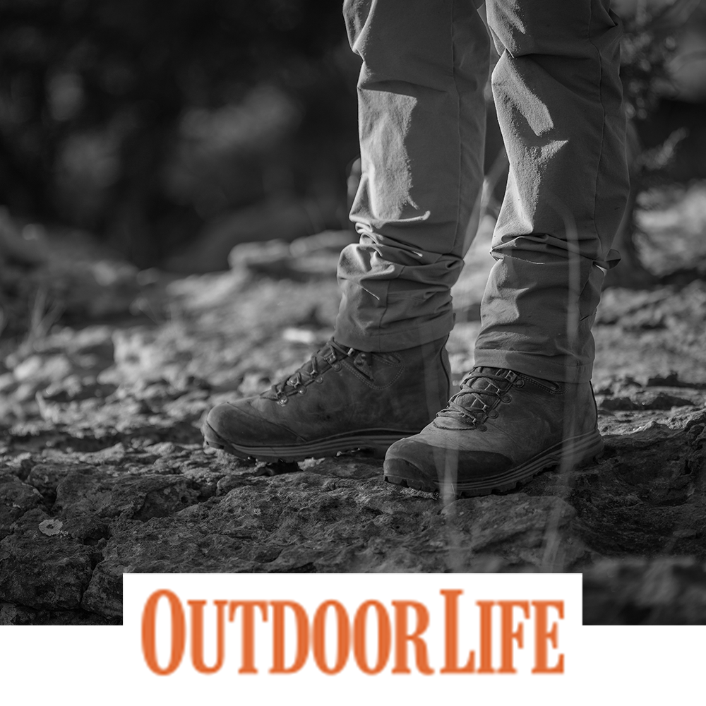 Meindl Comfort Fit Hunter 400 – As Featured in Outdoor Life Magazine – 400g Insulated Leather Hunting Boot Worn by Hunter Standing on Rocky Terrain in Open Field