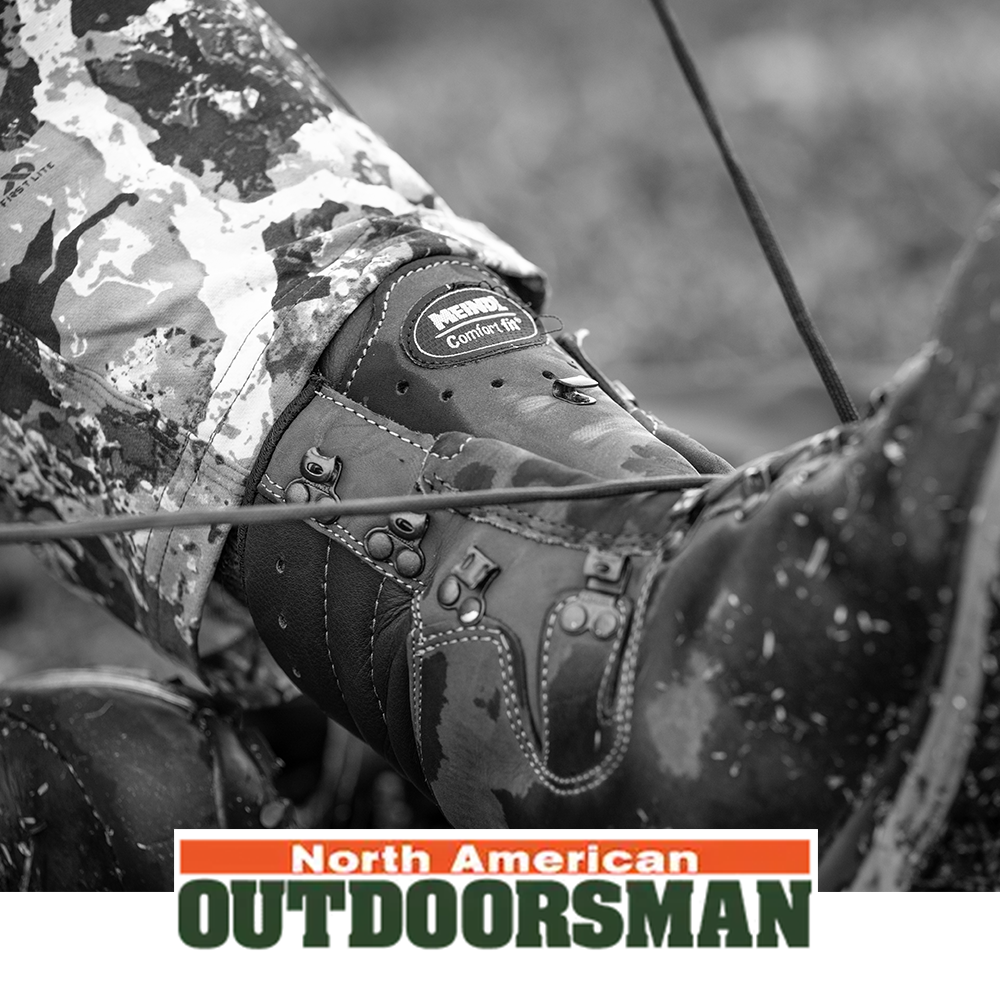 Meindl Comfort Fit Hunter Uninsulated – As Featured in North American Outdoorsman – Uninsulated Leather Hunting Boot With Comfort Fit Badge Visible on Hunter in Camouflage Kneeling in Field With Bow