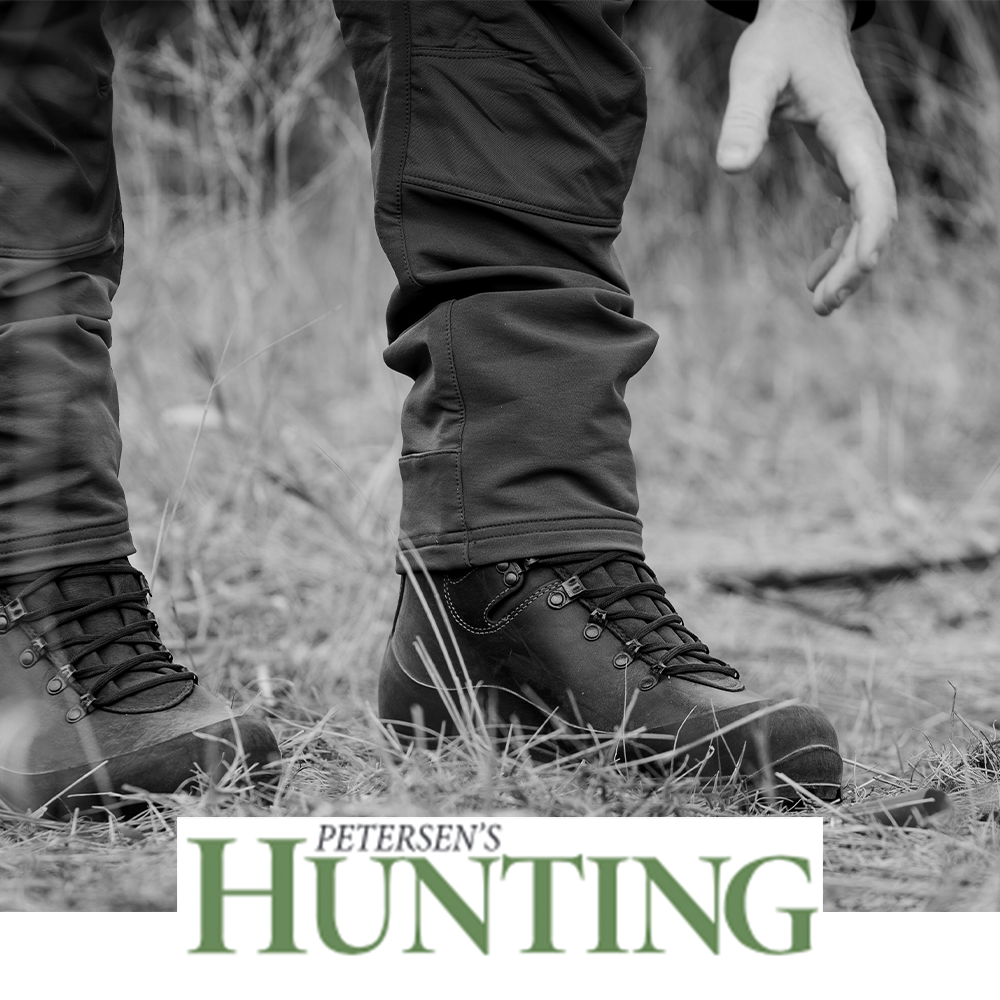 Meindl Comfort Fit Pro Hunter 300 – Black and White Photo of Hunter Walking Through Dry Grass Field in Meindl Hunting Boots as Featured in Petersen's Hunting