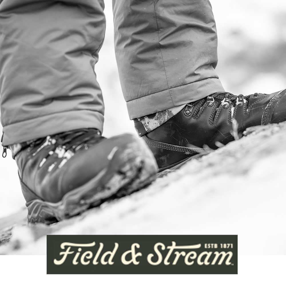 Meindl EuroLight Hunter 300 – As Featured in Field and Stream Magazine – 300g Insulated Lightweight Hunting Boot Worn by Hunter in Camouflage Standing on Snow-Dusted Rocky Terrain in Winter Conditions