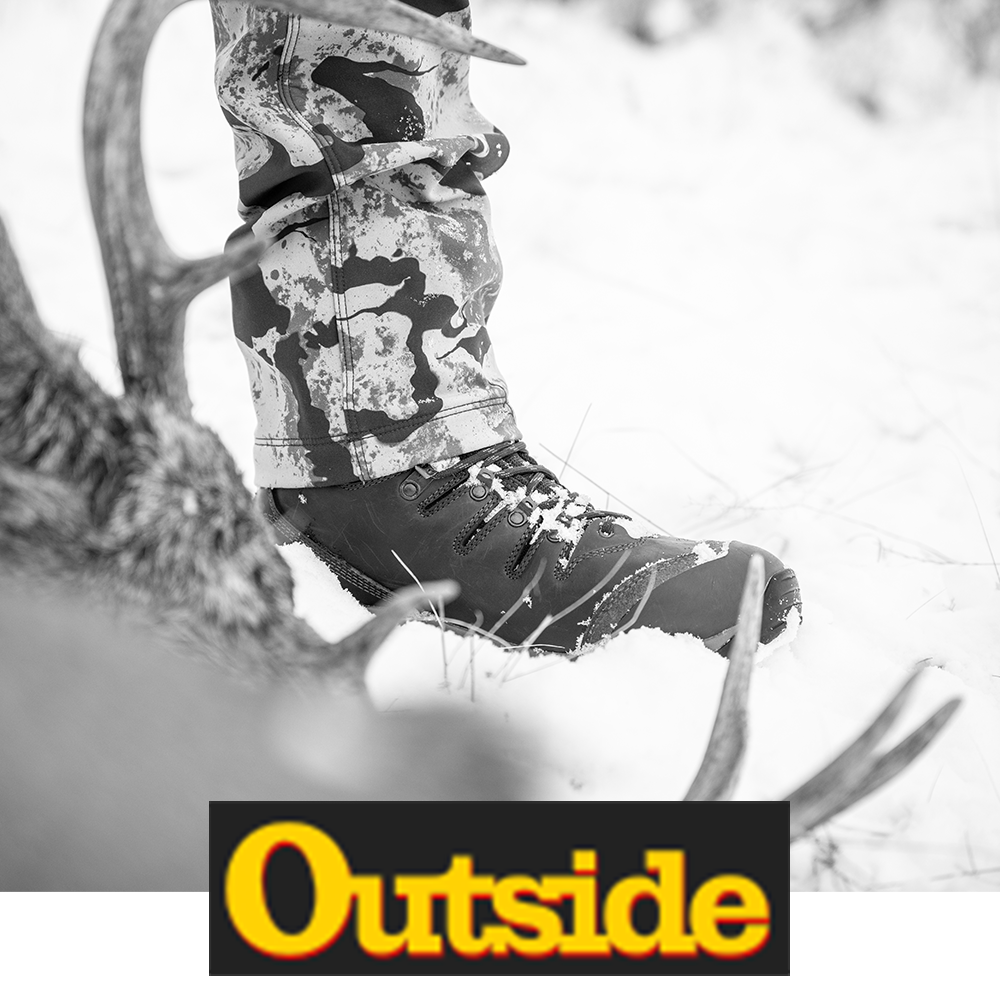 Meindl EuroLight Hunter 300 – As Featured in Outside Magazine – 300g Insulated Lightweight Hunting Boot Worn by Hunter in Camouflage Standing in Snow Beside Large Buck Antlers