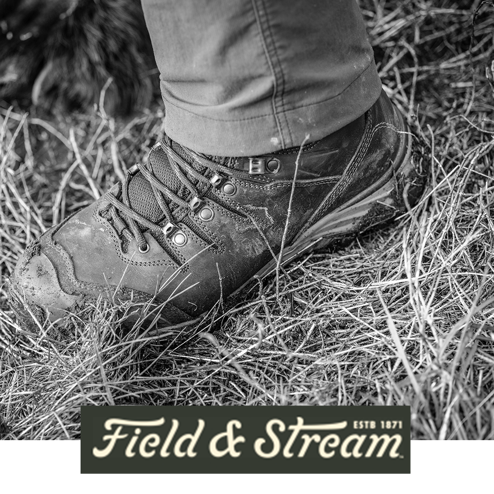 Meindl EuroLight Hunter Uninsulated – As Featured in Field and Stream Magazine – Lightweight Leather Hunting Boot Worn by Hunter Stepping Through Dry Grass Field With Hunting Dog Visible in Background