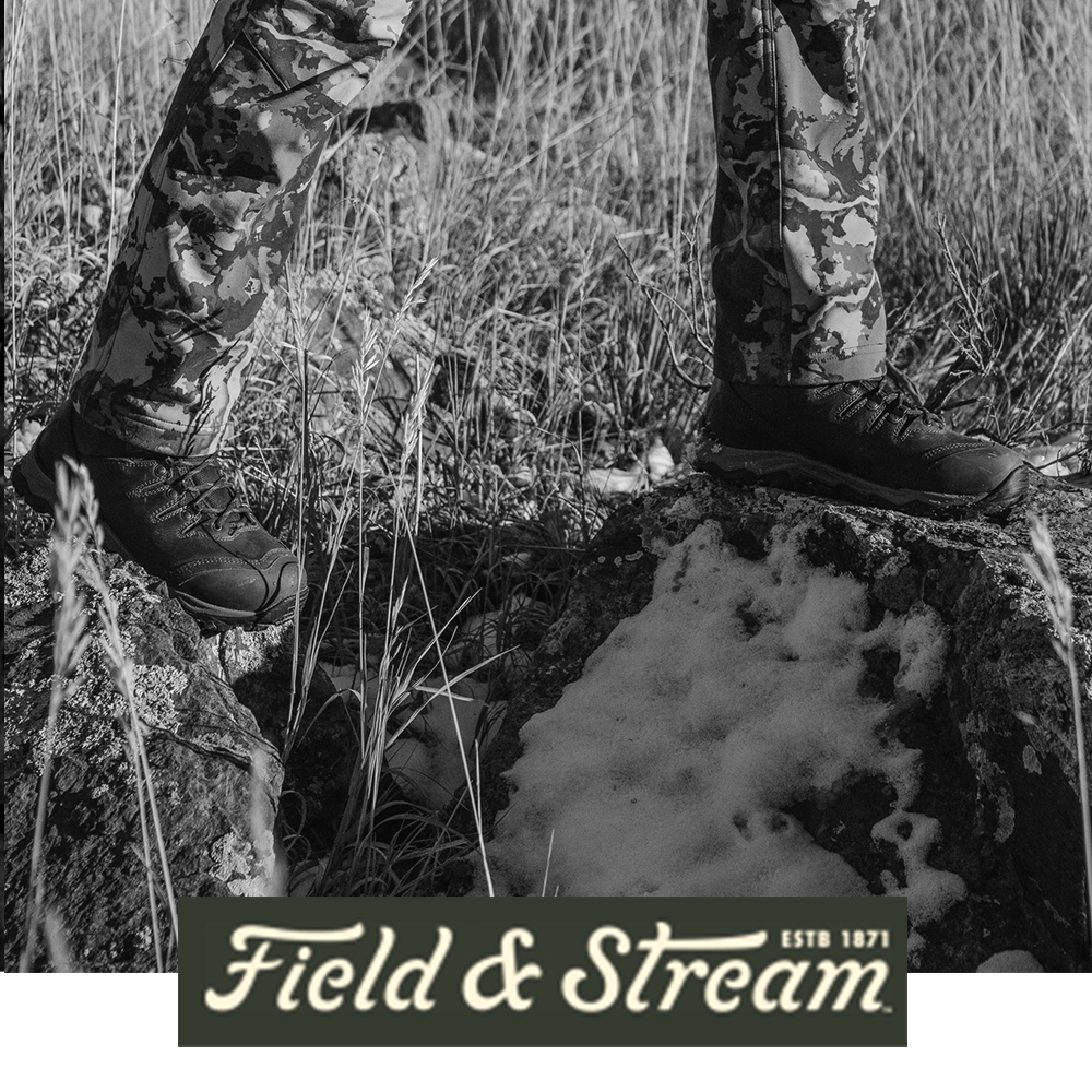 Meindl Lady EuroLight Hunter 300 – As Featured in Field and Stream Magazine – Women's 300g Insulated Lightweight Hunting Boot Worn by Female Hunter in Camouflage Standing on Snow-Covered Rocky Terrain