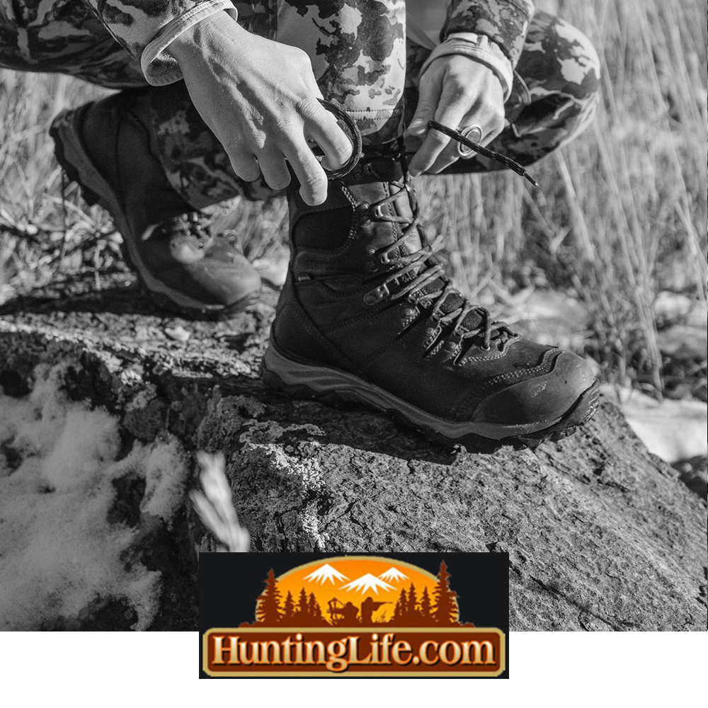 Meindl Lady EuroLight Hunter 300 – As Featured in HuntingLife.com – Women's 300g Insulated Lightweight Hunting Boot Being Laced by Female Hunter in Camouflage Sitting on Rocky Surface in Cold Winter Conditions