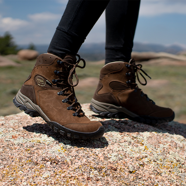 Meindl Lady Meran GTX – Brown Nubuck Leather Women's Gore-Tex Hiking Boot Worn on Granite Rock Outcrop With Mountain Vista and Blue Sky in Background
