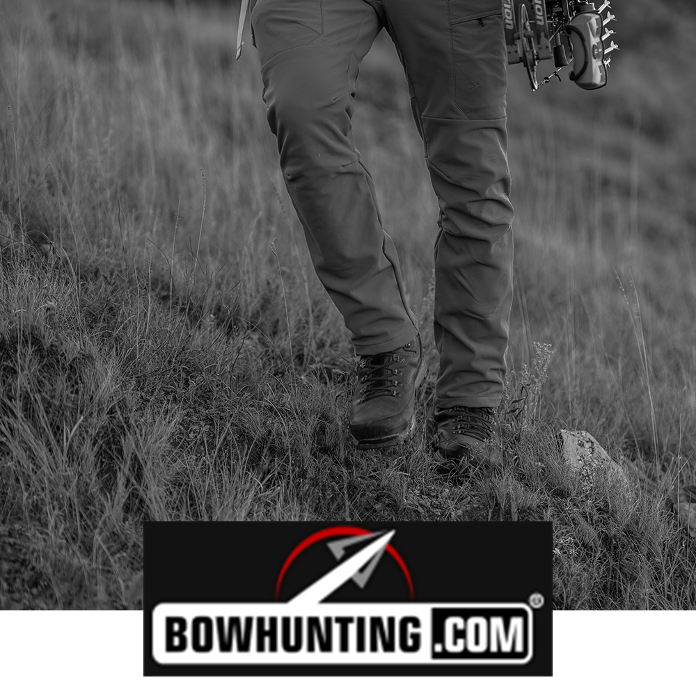Meindl MFS Vakuum Hunter – As Featured in Bowhunting.com – Waterproof Hunting Boot Worn by Bowhunter Carrying Compound Bow Across Open Grassland Terrain