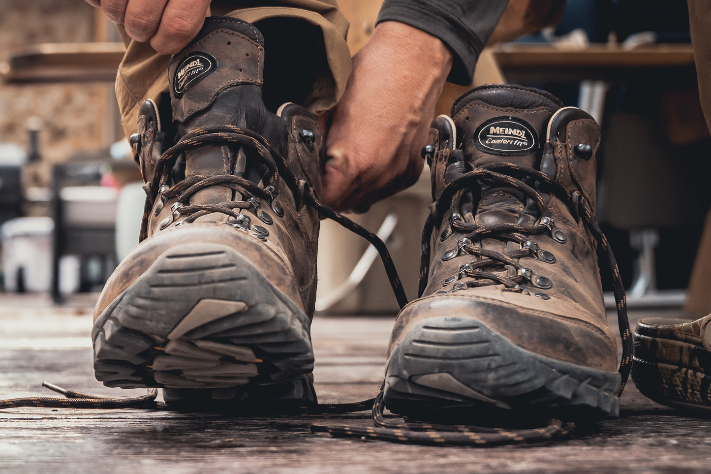 Meindl Comfort Fit Light Hiker – Brown Leather Comfort Fit Hiking Boot Being Laced Up Indoors Before Heading Out on the Trail